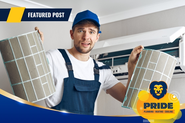 Technician inspecting HVAC system in a home