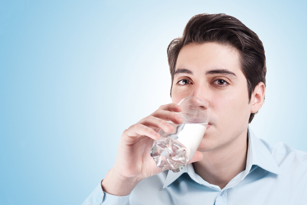 a person drinking a glass of water